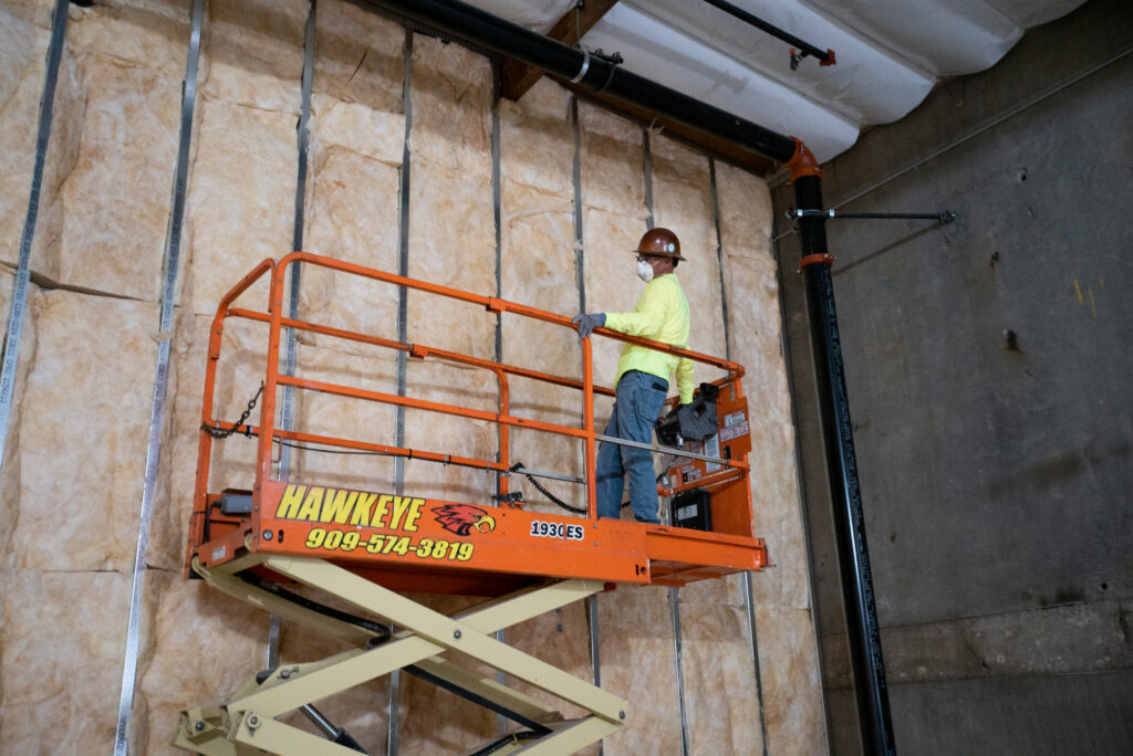 An insulation contractor installing insulation in a commercial building in Charlotte