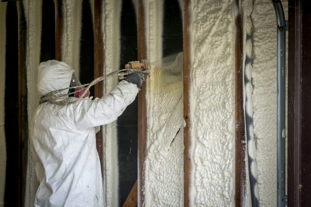 An insulation contractor installing spray foam insulation in Charlotte