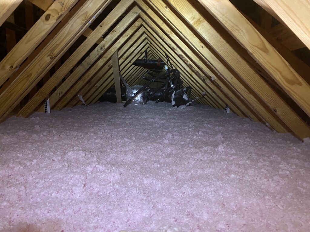 Fiberglass blown-in insulation in an attic in Charlotte, NC
